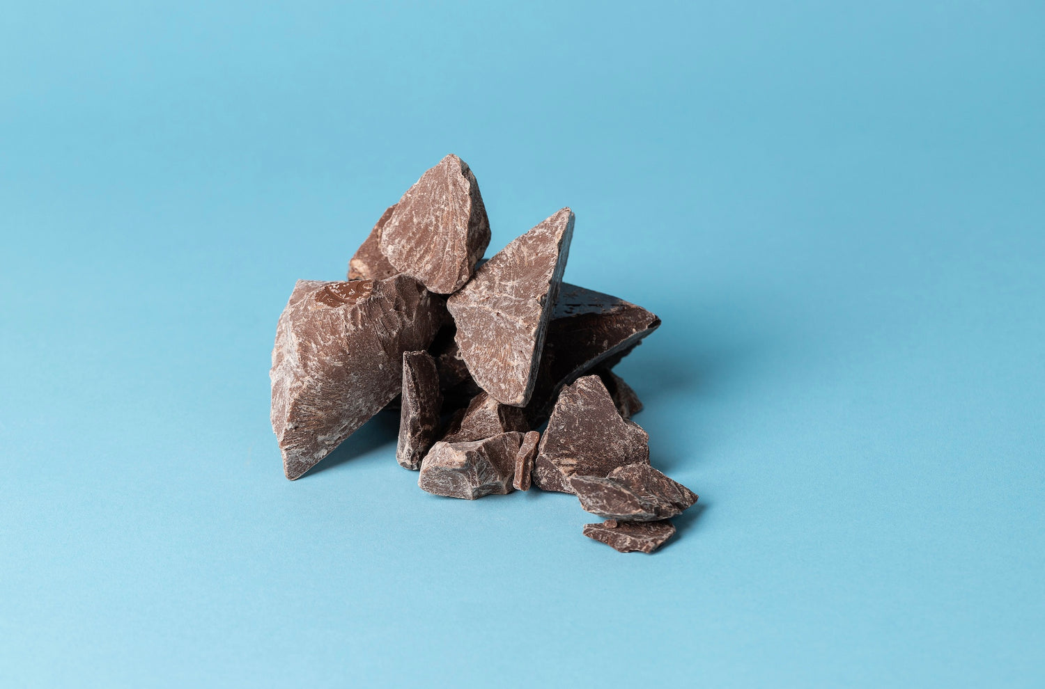 A pile of jagged, dark chocolate chunks